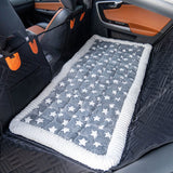 Gray star-pattern version of the Luxe Dog Bed on a back seat